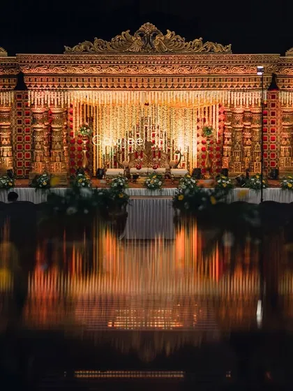 A breathtaking wide shot of the temple-style wedding stage, with its reflection creating a stunning visual.