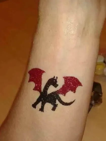 A fierce little dragon in black and red glitter. This is a fantastic choice for fantasy, castle, or mythical creature-themed events.