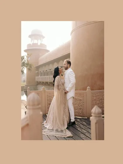 A romantic, framed portrait of Priyanka and Luke sharing a moment on a bridge at the Rajvilas. The warm tones give this image a soft, dreamy quality.