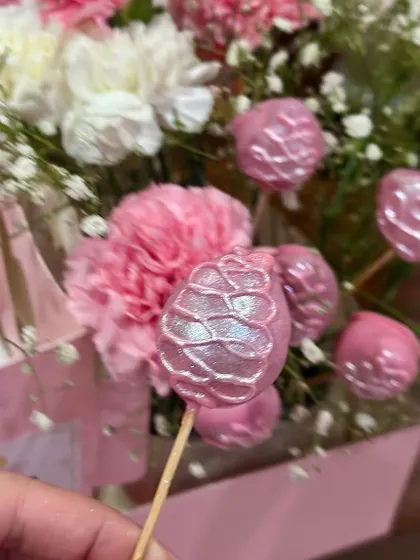 A detailed shot of our shimmering, pinecone-shaped cake pops. These were part of a Mother's Day hamper, showing the unique add-ons we can create.