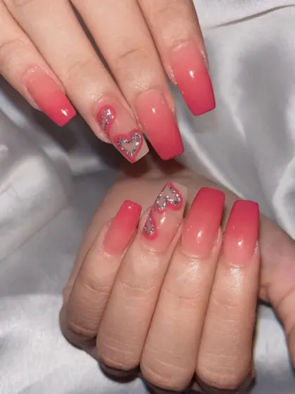 A lovely pink ombre set with a glitter heart accent nail.