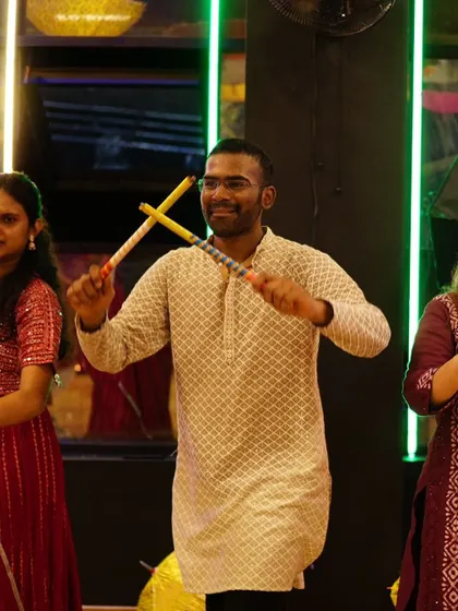 A student fully engaged in learning Dandiya Raas steps. Our choreography focuses on authentic moves that are easy for everyone to pick up.