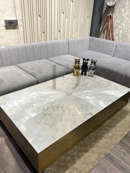 An ultra-luxurious center table featuring a selenite crystal top with a radiant pattern. The brass base adds warmth and complements the ethereal quality of the selenite.