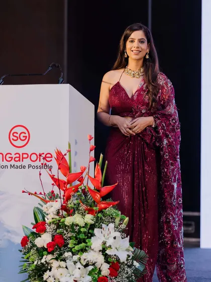A poised moment by the lectern at the Singapore Tourism event. My attire and stage presence are carefully chosen to reflect the sophistication and vibrancy of the brand I am representing.