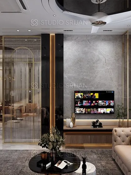 The drawing room in the Bali Nagar project, with a tufted sofa, a dark marble-paneled wall, and elegant glass and brass partitions.