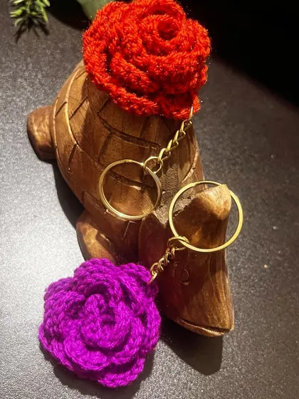 My new rose keychains are here! This red and purple one are being modeled by my little turtle friend, Leo.
