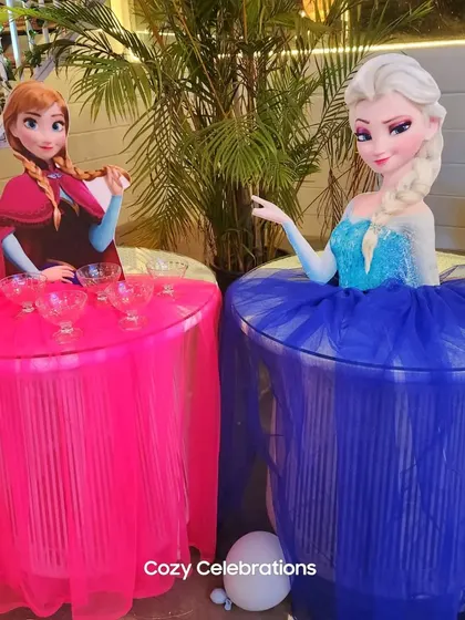 I also create themed tables, like these Elsa and Anna tables with tulle skirts, perfect for serving treats at a Frozen party.