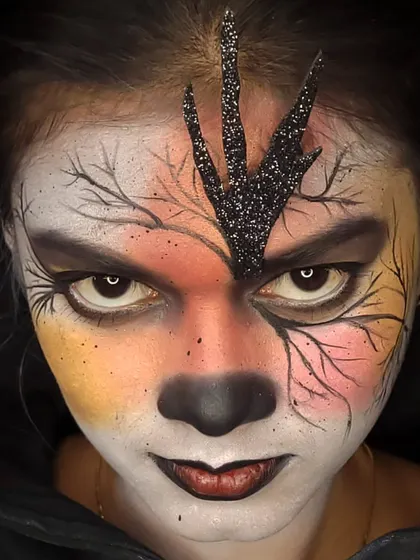 A close-up of my gothic fantasy creation. This look features intricate, hand-painted branches, a warm-to-cool color gradient on the skin, and dramatic white contact lenses to complete the eerie, enchanted forest vibe.
