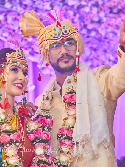 A hopeful and symbolic portrait. The groom points towards the distance as they stand together, a beautiful metaphor for the start of their new life.
