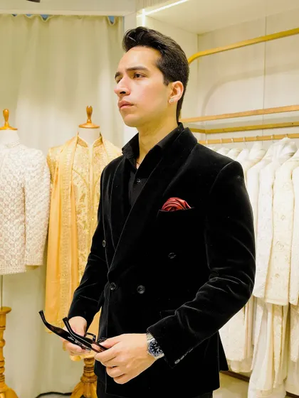The full view of the classic black velvet tuxedo. This piece is all about the perfect cut and luxurious material, proving that sometimes the simplest designs are the most powerful.