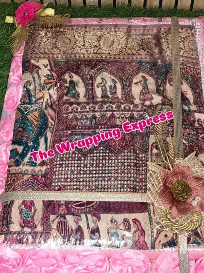 This shawl with traditional motifs is packed in a box with matching pink rose decorations.