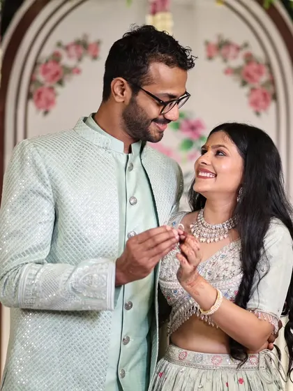 A beautiful moment where the couple looks at each other while showing their engagement rings.