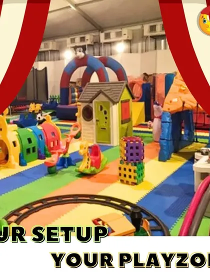 Our setup, your playzone. This image shows a massive indoor play area inside a large tent, complete with a train track, climbing wall, trampoline, and multiple playhouses. It's the ultimate party experience.