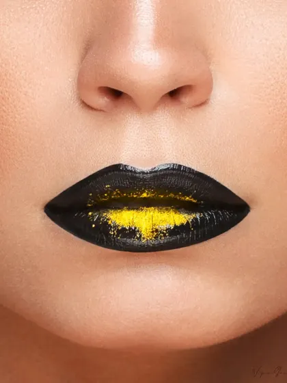 An extreme close-up of the lips, featuring a creative black and yellow glitter effect. This kind of detailed shot is perfect for advertising lip products or showcasing makeup artistry.