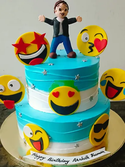 An emoji-themed cake that expresses all the fun of a birthday, with various handcrafted emoji faces and a personalized topper.