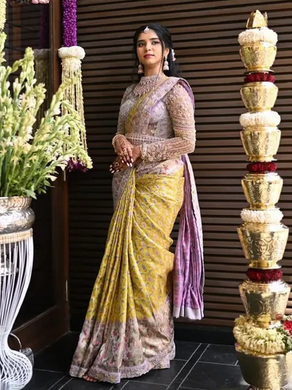 A full view of this elegant ensemble. The full-sleeved embroidered blouse and the flowing saree create a look of timeless sophistication.