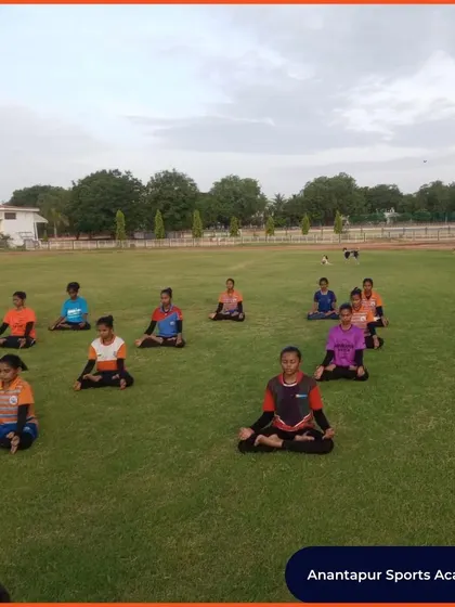 Athletes from Anantapur Sports Academy practice meditation on the field. A calm and focused mind is a powerful asset for any competitor.