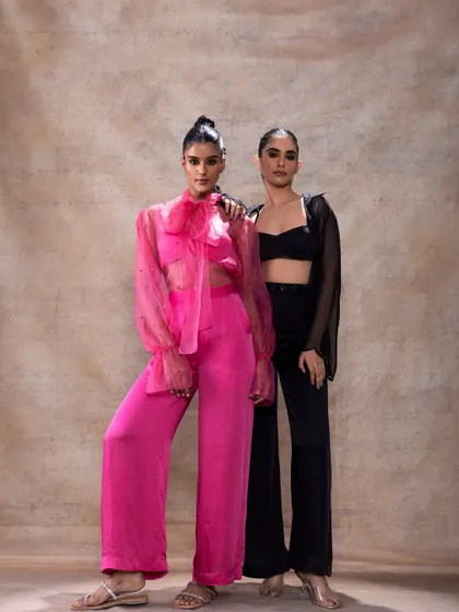 A full-length shot of two models for Akashi Clothing. I designed complementary makeup looks that work for both the bright pink and classic black outfits, showcasing versatility.