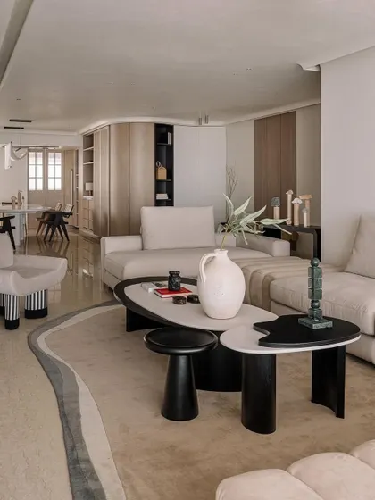 A wide view of the Kanso House living room, showcasing the open layout and connection to the dining area. The design emphasizes space and light, creating a home that feels expansive and serene.
