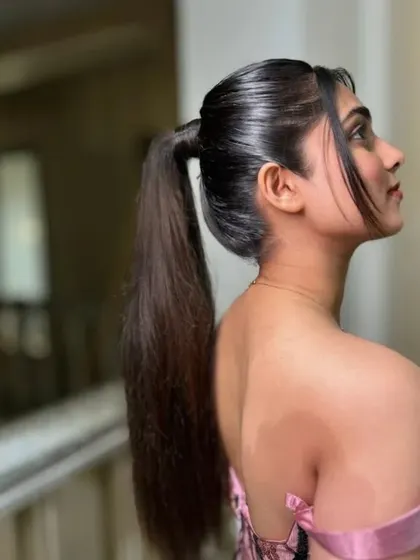 A high, sleek ponytail is a statement look. This style is perfect for a modern bride or for a cocktail event, creating a sharp and confident silhouette.