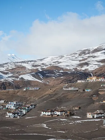 A series of images capturing the life and landscapes around Spiti's villages and monasteries. These photos feature local people, homes nestled in the hills, and the ever-present mountain dogs.