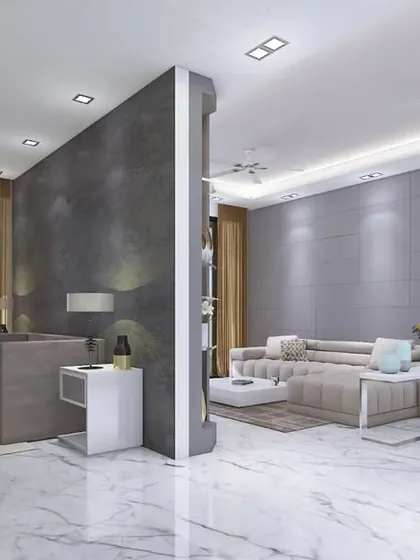 An open-plan living space in the Crescent Bay apartment, with a low-profile sofa and white marble flooring.
