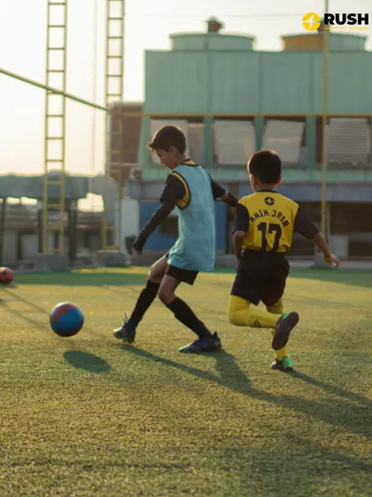 Two players in a one-on-one duel during a training match at sunset. These moments of healthy competition are where players sharpen their skills.