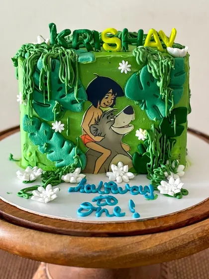 Look for the bare necessities! A Jungle Book cake for a "Halfway to One" celebration, featuring Mowgli and Baloo. The jungle vines and leaves are all piped with buttercream.