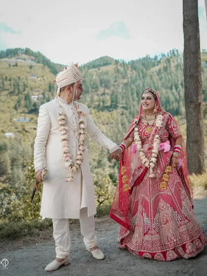 A classic wedding portrait of a couple in Jubbal, holding hands on a mountain path. The natural setting provides a serene and beautiful canvas for their portrait.