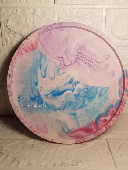 An extra-large round tray with a dreamy pink, purple, and blue marble effect. It's a statement piece for any room.