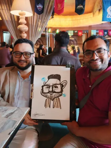 Two colleagues enjoying their caricature. It's a fun way to bond with teammates at a corporate party.