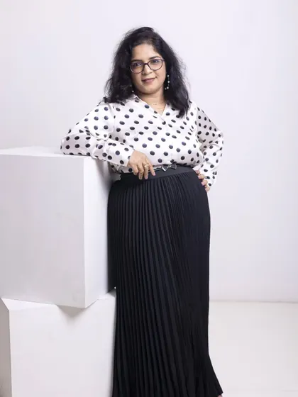 Another powerful shot of Kala. Notice how the belted waist on the pleated skirt creates a defined silhouette. Small details like this are key to creating a polished and intentional look that commands respect.