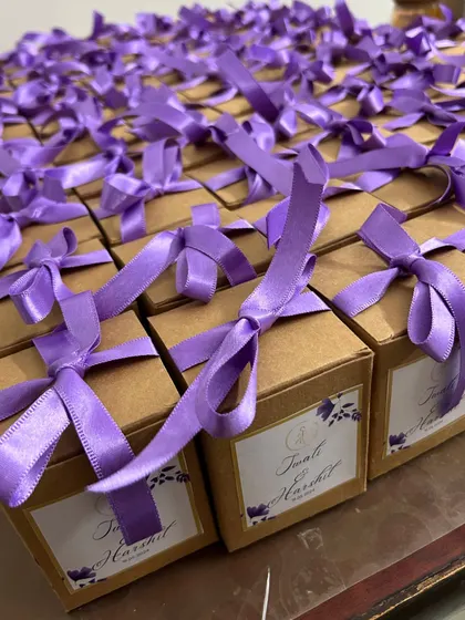 A sea of purple ribbons. It’s so satisfying to see a large wedding favor order come together, with each box perfectly tied and ready for the celebration.