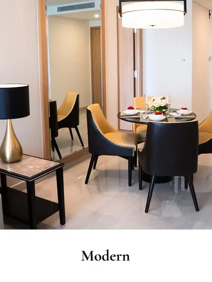A dining area that feels as good as it looks. This modern, warm, and effortlessly functional space features two-toned chairs and a simple, elegant table setting.