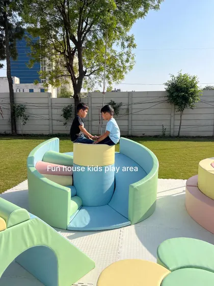 Two children playing on our unique curved pastel slide and climber, designed for interactive and cooperative fun.