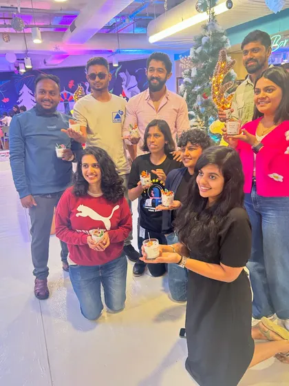 A group proudly displays their finished dessert candles at a Christmas party. These events are a fantastic way to combine celebration with a fun, creative activity.
