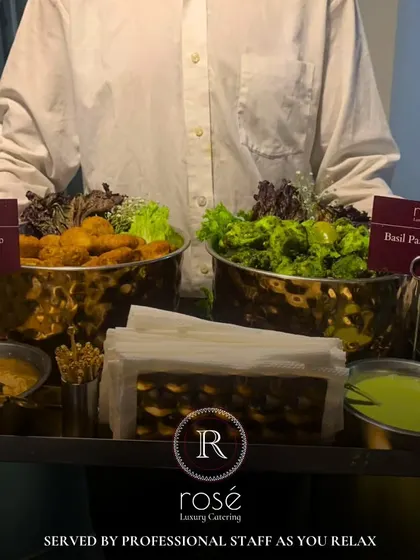 A server presenting two of our signature appetizers: Truffle Dahi Kebab and Basil Paneer Tikka. Our professional staff ensures that you can relax while we handle every detail of the service.