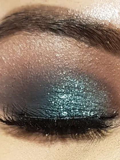 Here is the same teal glitter eye makeup with my eye closed. You can see the smooth blending from the brown transition shade to the deep teal and the pop of glitter on the lid.