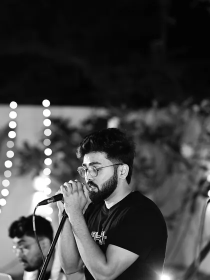 A moment of complete focus during a live show. This black and white shot captures the intensity and emotion I bring to every performance, whether it's for a large crowd or a small gathering.