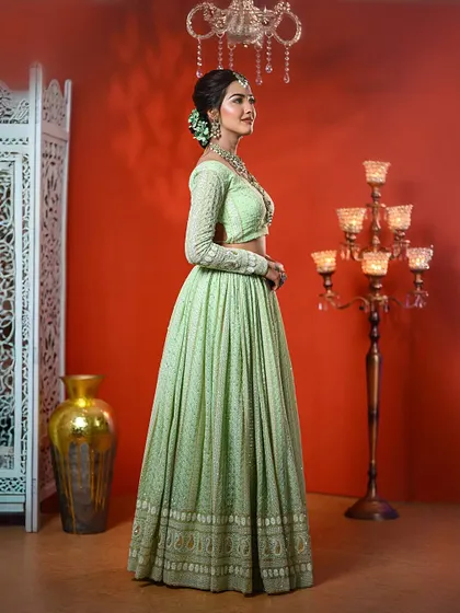 The full view of the pastel green Lucknowi lehenga, perfect for a summer wedding or day event.