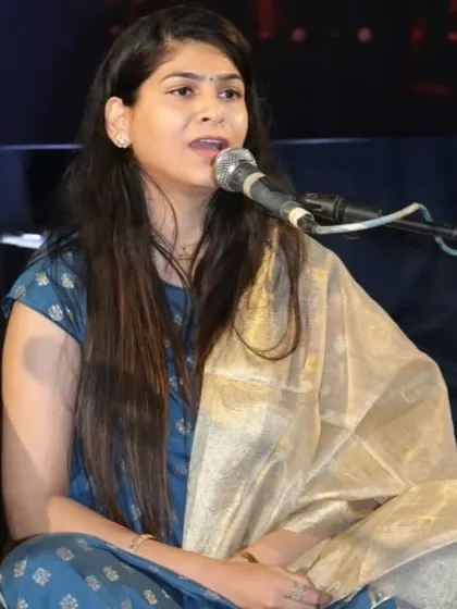 A close-up of a student vocalist during the Raag Miya Malhar performance, capturing her expressive singing style.