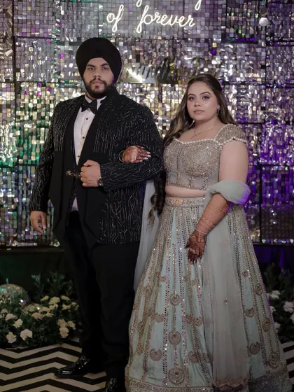 The bride and groom at their Sagan and Sangeet night. Her glamorous waves are the perfect complement to her festive attire.