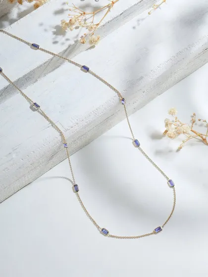 The Tanzanite Gold Chain, a simple yet luxurious piece featuring tanzanite stations along a fine chain. It's a piece that glows as uniquely as you do.