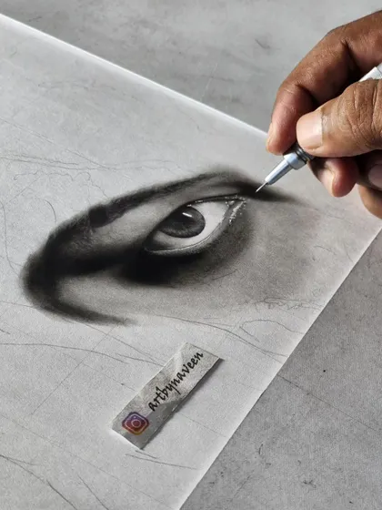 A shot of my hand working on the eye, using a mechanical pencil for fine details.
