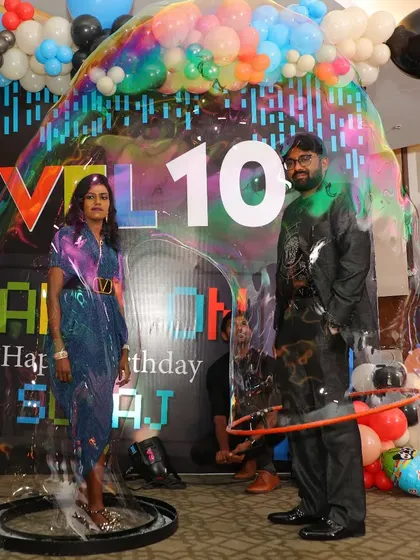 Our bubble act is perfect for couples and anniversaries. Here, we've captured two guests inside a single giant bubble at a 10th anniversary party, creating a unique and memorable photo for their celebration.