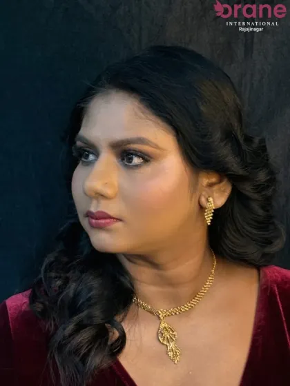 A profile view that showcases the soft, voluminous hairstyle created to complement the makeup.