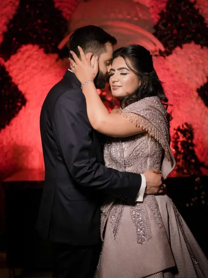 An intimate embrace during an engagement party. The soft lighting and close framing highlight the emotional connection and love between the couple.