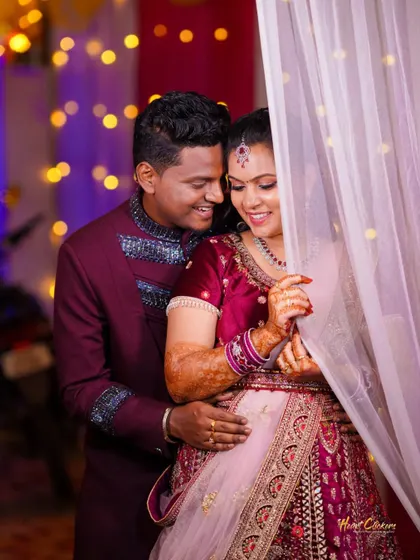 A cozy and romantic moment between the couple, framed by a sheer curtain and bokeh lights. This shot feels intimate and magical.