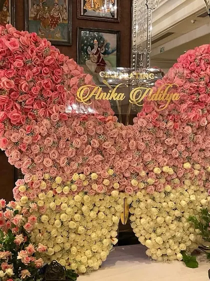 We crafted this breathtaking butterfly backdrop from hundreds of fresh pink and cream roses for a truly magical cradle ceremony. This statement piece creates a stunning focal point and a perfect photo opportunity, celebrating new life in the most beautiful way.