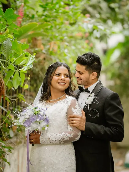 A beautiful outdoor shot of Eliza and Cleevan. Her makeup and hair were designed to look fresh and elegant, complementing the natural setting perfectly.